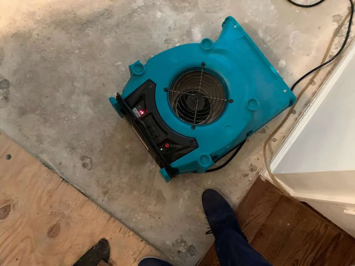 Air mover drying subfloor during Leak Detection & Repair in Hyrum